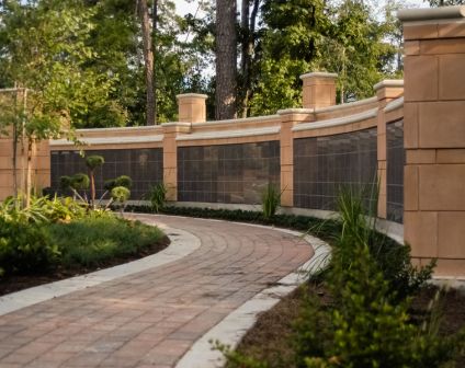 Curved brick paver walkway with stone wall